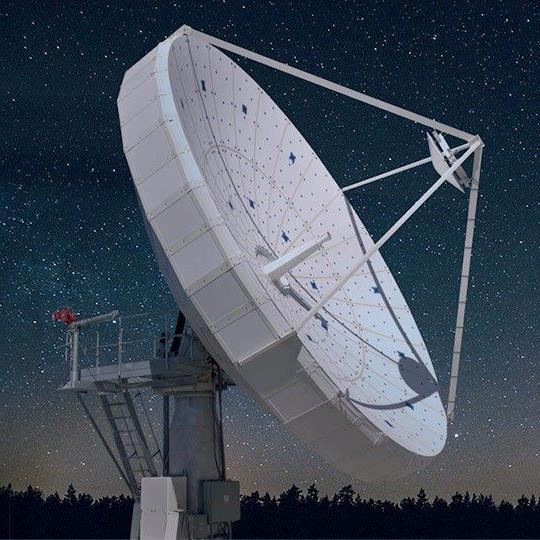 Large ground antenna in front of stars across the night sky